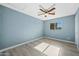 Well-lit bedroom with ceiling fan and wood-look floors at 5927 W Mulberry Dr, Phoenix, AZ 85033