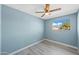 Bright bedroom with window and ceiling fan at 5927 W Mulberry Dr, Phoenix, AZ 85033