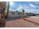 Newly renovated single story home with gray exterior and palm trees at 5927 W Mulberry Dr, Phoenix, AZ 85033