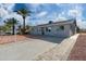 Newly renovated single story home with gray exterior, driveway and walkway at 5927 W Mulberry Dr, Phoenix, AZ 85033