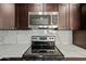 Modern kitchen with dark cabinetry and quartz countertops at 5927 W Mulberry Dr, Phoenix, AZ 85033