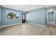 Light and bright living room with light wood floors and blue walls at 5927 W Mulberry Dr, Phoenix, AZ 85033