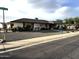 Ranch-style home with landscaped yard, featuring a long driveway and decorative fountain at 5929 E Duncan St, Mesa, AZ 85205