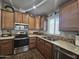 Modern kitchen with stainless steel appliances and wood cabinets at 650 N Hawes Rd # 3431, Mesa, AZ 85207