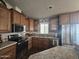 Bright kitchen, featuring stainless steel appliances and wood cabinets at 650 N Hawes Rd # 3431, Mesa, AZ 85207