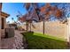 Landscaped backyard with grassy area, brick path and block wall at 660 N Maple St, Chandler, AZ 85226