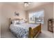 Bedroom with a floral comforter and ceiling fan at 660 N Maple St, Chandler, AZ 85226