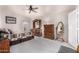 Cozy bedroom with wooden furniture and a ceiling fan at 660 N Maple St, Chandler, AZ 85226