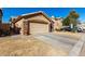 House exterior showcasing stone accents and a two-car garage at 660 N Maple St, Chandler, AZ 85226