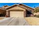 House exterior with stone accents and a two-car garage at 660 N Maple St, Chandler, AZ 85226