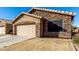 House exterior with stone accents and a two-car garage at 660 N Maple St, Chandler, AZ 85226