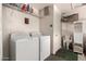 Laundry room with washer, dryer and ample storage shelving at 660 N Maple St, Chandler, AZ 85226