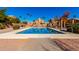 Community pool with palm trees and seating areas at 660 N Maple St, Chandler, AZ 85226