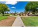 A curved path winds through a grassy area with unique landscaping at 6820 S Rita --, Tempe, AZ 85283