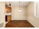 Dining area with wood-look floors and pendant lighting at 6820 S Rita --, Tempe, AZ 85283