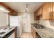 Kitchen with granite countertops and wood cabinets at 6820 S Rita --, Tempe, AZ 85283