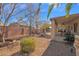 Covered patio, gravel yard, and mature trees in backyard at 6825 S Whetstone Pl, Chandler, AZ 85249