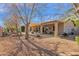 Large backyard with gravel, mature trees, and covered patio at 6825 S Whetstone Pl, Chandler, AZ 85249