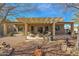 Spacious backyard with covered patio, fire pit, and mature landscaping at 6825 S Whetstone Pl, Chandler, AZ 85249