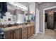 Elegant bathroom with dual sinks, granite vanity, and walk-in shower at 6825 S Whetstone Pl, Chandler, AZ 85249