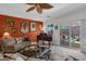 Relaxing living room with a piano, comfortable seating, and access to patio at 6825 S Whetstone Pl, Chandler, AZ 85249