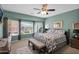 Serene main bedroom with ceiling fan and bay window overlooking backyard at 6825 S Whetstone Pl, Chandler, AZ 85249