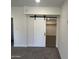 Spacious bedroom closet with barn door and ample hanging space at 7015 N 23Rd Ln, Phoenix, AZ 85021