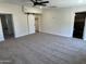 Spacious bedroom with carpet, ceiling fan and barn door closet at 7015 N 23Rd Ln, Phoenix, AZ 85021