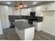 Updated kitchen with sleek gray countertops and white cabinets at 7015 N 23Rd Ln, Phoenix, AZ 85021