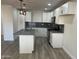 Modern kitchen featuring white cabinets and a large island at 7015 N 23Rd Ln, Phoenix, AZ 85021