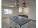 Open concept kitchen with modern pendant lights and island at 7015 N 23Rd Ln, Phoenix, AZ 85021