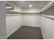 Large walk-in closet with double hanging rods and neutral carpeting at 7015 N 23Rd Ln, Phoenix, AZ 85021