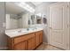 Double vanity bathroom with a large mirror and linen closet at 7019 W Mcmahon Way, Peoria, AZ 85345