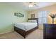 Light and airy bedroom with a ceiling fan and wood flooring at 7019 W Mcmahon Way, Peoria, AZ 85345