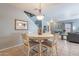 View of dining area with a round table and four chairs, near stairs and living room at 7019 W Mcmahon Way, Peoria, AZ 85345