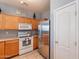 View of kitchen with stainless steel appliances and oak wood cabinets at 7019 W Mcmahon Way, Peoria, AZ 85345