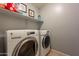 Practical laundry room with washer, dryer, and shelving at 7019 W Mcmahon Way, Peoria, AZ 85345