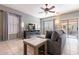 Living room with L-shaped sofa, TV, fireplace, and patio access at 7019 W Mcmahon Way, Peoria, AZ 85345