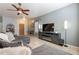 Living room with sectional sofa, fireplace, and large windows at 7019 W Mcmahon Way, Peoria, AZ 85345