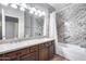 Guest bathroom with double vanity and granite shower surround at 7132 W Villa Chula --, Glendale, AZ 85310