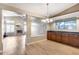 Dining room with wood floors and view of the living room with fireplace at 7132 W Villa Chula --, Glendale, AZ 85310