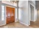 Front entry foyer with wood door, chandelier and view of the hallway at 7132 W Villa Chula --, Glendale, AZ 85310