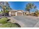 Three car garage with large driveway and landscaping at 7132 W Villa Chula --, Glendale, AZ 85310