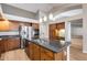 Kitchen with dark wood cabinets and granite island at 7132 W Villa Chula --, Glendale, AZ 85310