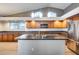 Kitchen with dark wood cabinets and granite island at 7132 W Villa Chula --, Glendale, AZ 85310