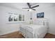 Bedroom with white metal bed frame, hardwood floors, and window with white shutters at 7501 N 22Nd Pl, Phoenix, AZ 85020