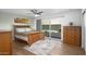 Bedroom with wooden bed frame, dresser, and sliding glass doors opening to a pool view at 7501 N 22Nd Pl, Phoenix, AZ 85020