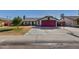 Cute single story home with a red garage door and well-maintained lawn at 7945 W Wethersfield Rd, Peoria, AZ 85381