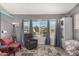 Living room with bay window, comfy seating, and built-in shelving at 7945 W Wethersfield Rd, Peoria, AZ 85381