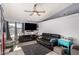 Living room with a black leather couch, teal side table, and fireplace at 7945 W Wethersfield Rd, Peoria, AZ 85381